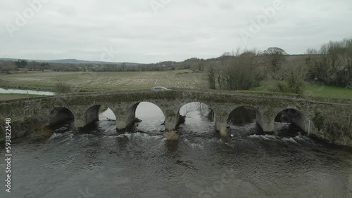 Car Passing Across An Old Bridge Over The Slane River In Wexford, Ireland. aerial photo