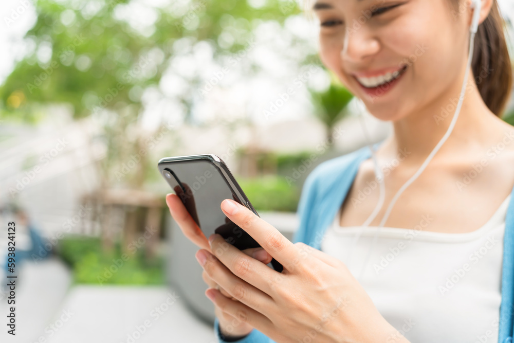 Woman using smartphone in public areas, During leisure time. The concept of using the phone is essential in everyday life. Woman using smartphone in public areas, During leisure time. The concept of using the phone is essential in everyday life.