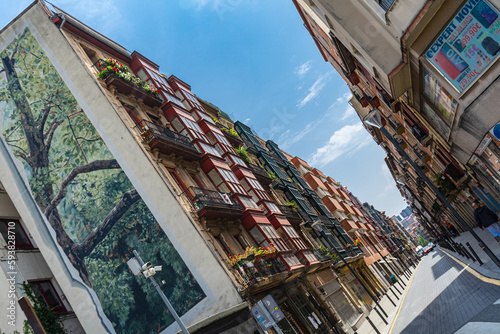 Bilbao, Spain - 10.06.2022: narrow streets with colorful balconies, angle view. photo