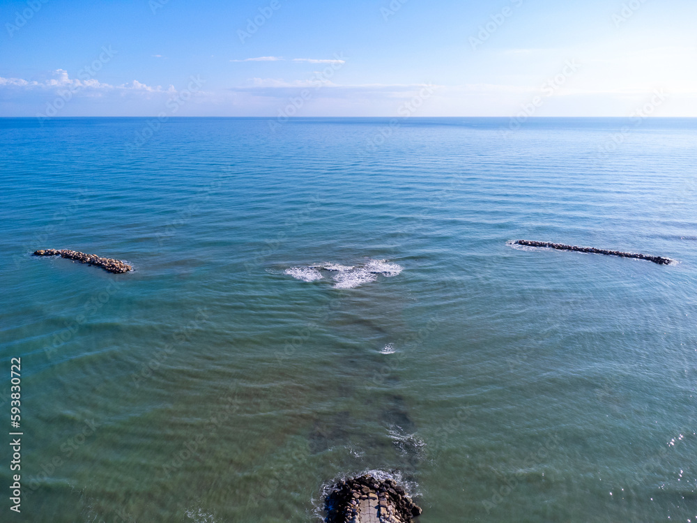 Aerial view landscape Italy Pescara. Sea, waves, breakwater, stones, rocks, beach, sand, empty.