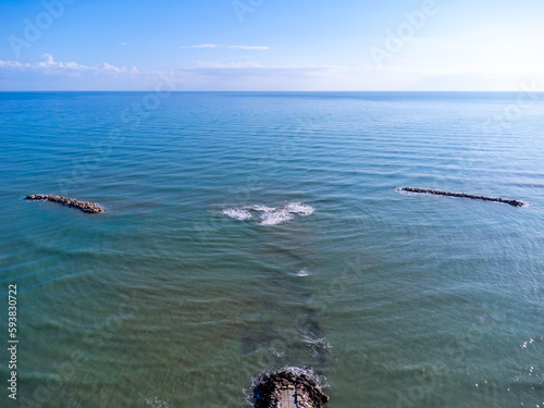 Obraz na płótnie Aerial view landscape Italy Pescara. Sea, waves, breakwater, stones, rocks, beach, sand, empty. w salonie