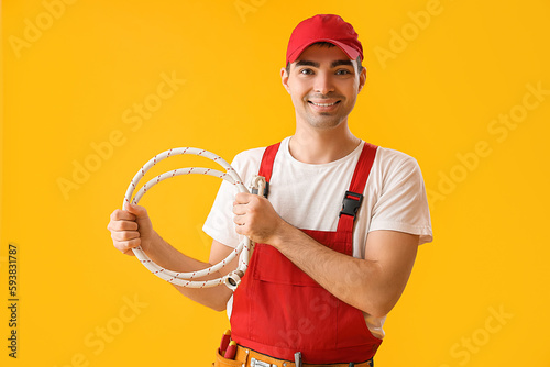 Young plumber with flexible...