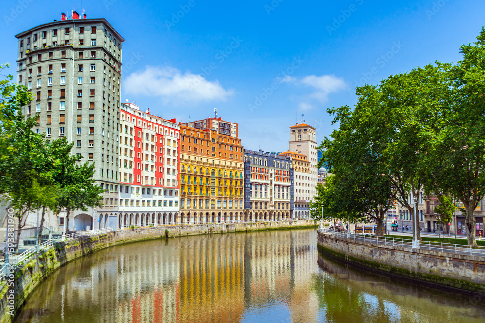 Obraz premium High apartment buildings along the Nervion River, Bilbao, Spain. Nervion river embankment in Bilbao.
