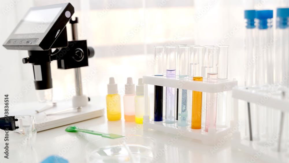 microscope and test tubes in a chemical laboratory microscope and test tubes in a chemical laboratory