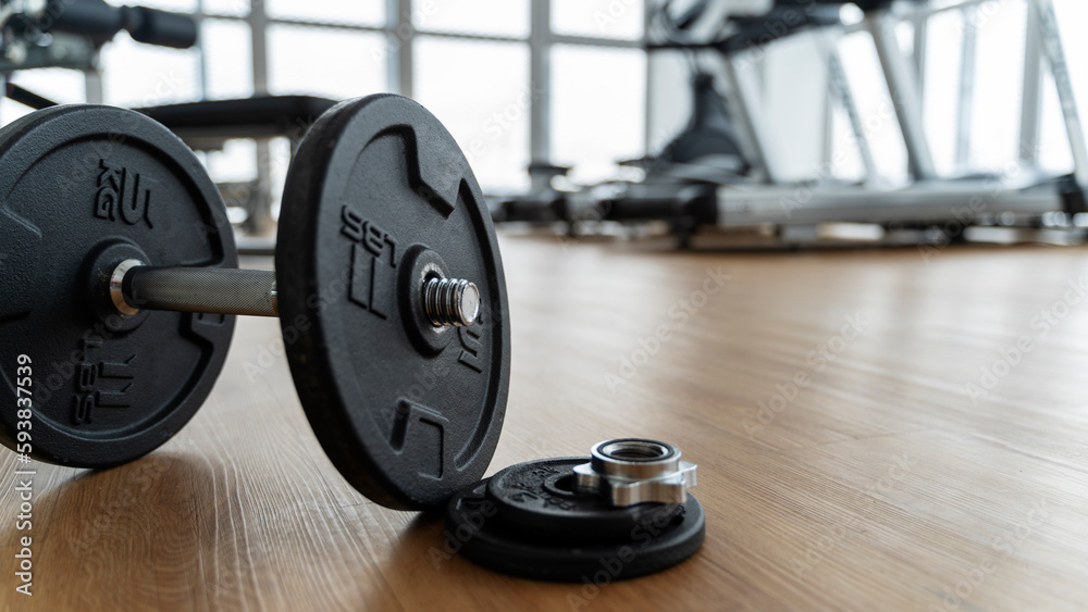 dumbbells in the gym on the floor, the concept of proper nutrition and fitness, a place for the inscription dumbbells in the gym on the floor, the concept of proper nutrition and fitness, a place for the inscription