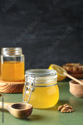 Jars of sweet honey on table