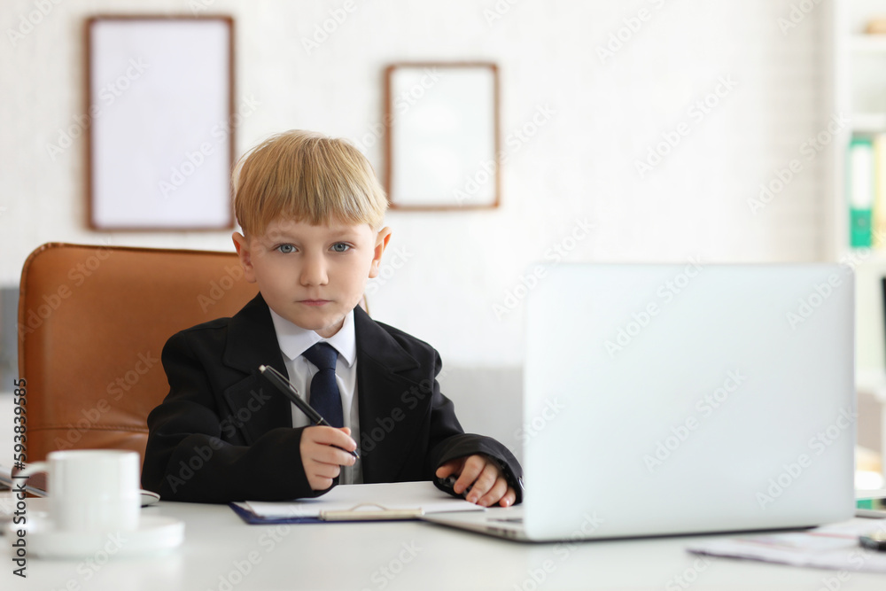 Funny little businessman working at table in office Funny little businessman working at table in office