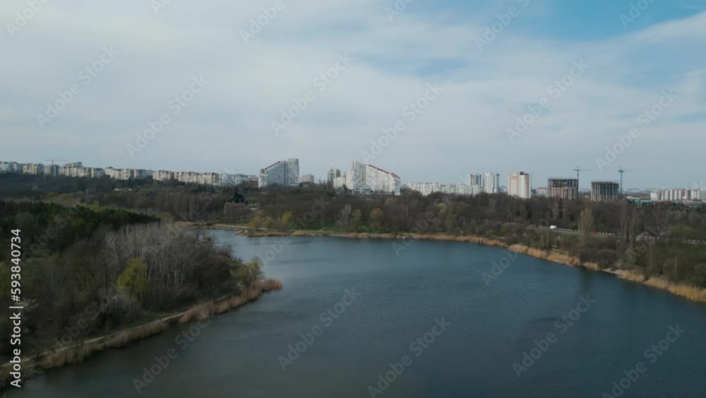 Establishing drone shot of Chisinau Bulevardul Dacia in Moldova in spring with lake in the foreground - Aerial 4k panorama view of the Chișinău City Gates Establishing drone shot of Chisinau Bulevardul Dacia in Moldova in spring with lake in the foreground - Aerial 4k panorama view of the Chișinău City Gates