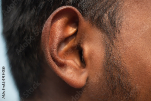 Black hair and beard around one ear and background blurred photo