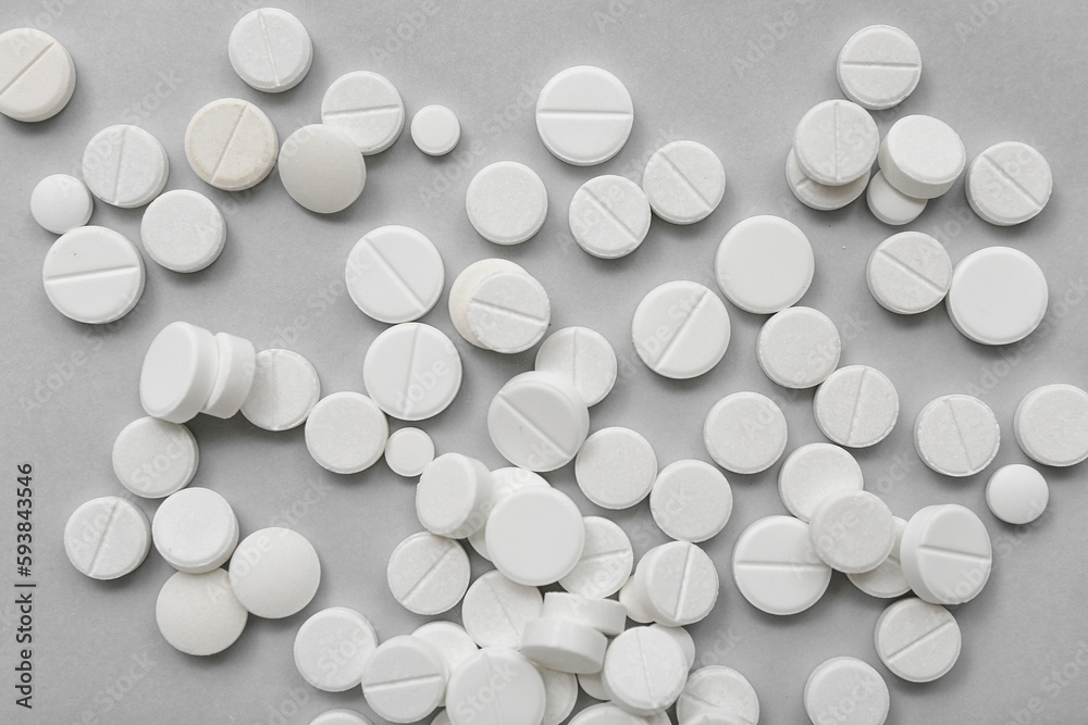 White pills on grey background White pills on grey background
