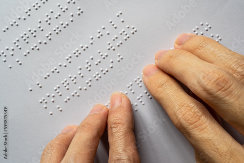 Blind person reading braille of alphabet A to Z