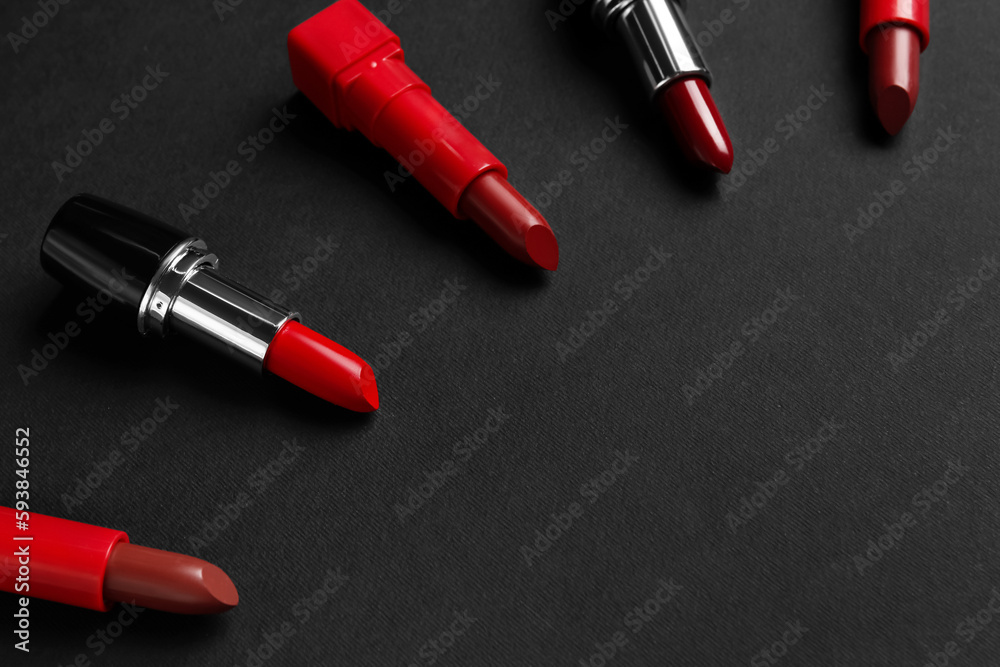 Composition with beautiful lipsticks on dark background Composition with beautiful lipsticks on dark background