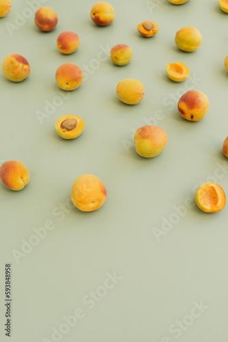 Aesthetic fruit background. Ripe juicy peaches on pastel green background. Fresh organic fruit vegan food