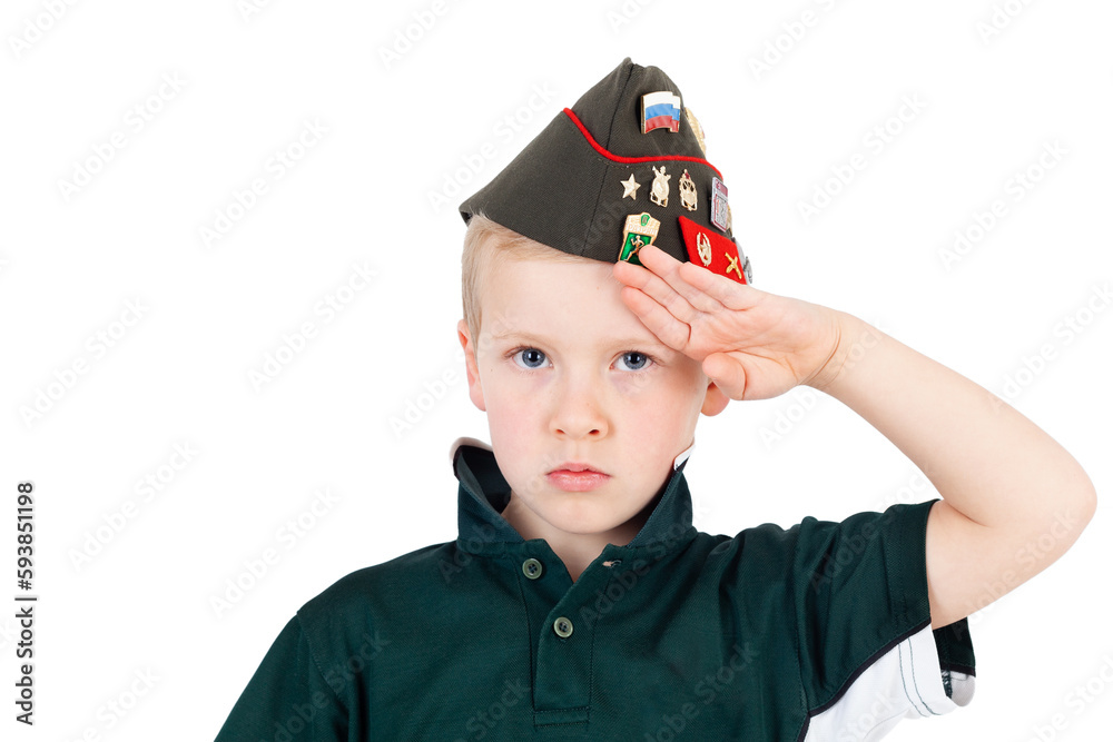 Young caucasian boy saluting playing dressups in green 'army' shirt and