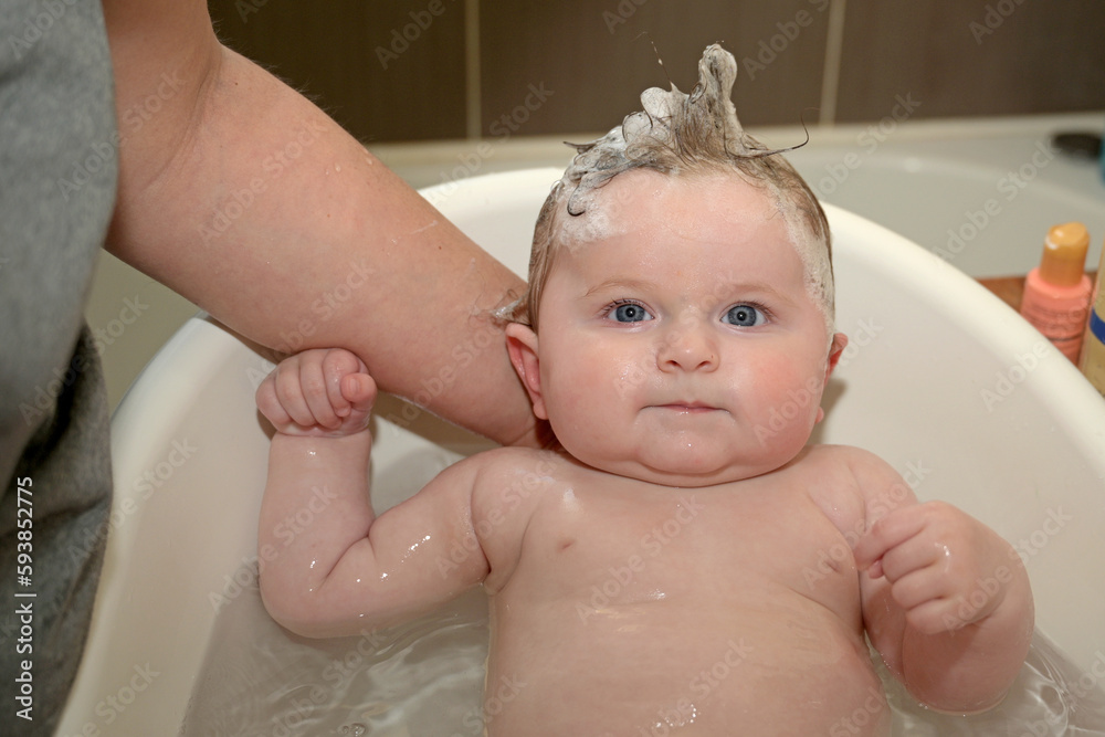 newborn smiling in his bath newborn smiling in his bath
