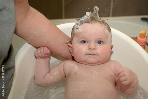 newborn smiling in his bath