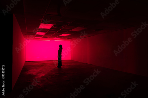 Silhouette of a person with pink neon light   © Kajornsiri