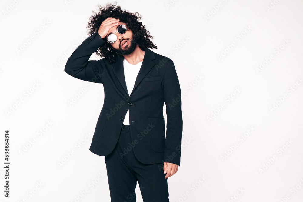 Handsome confident hipster model. Unshaven Arabian man dressed in summer suit jacket clothes. Fashion male with long curly hairstyle isolated on white in studio. Cheerful and happy. In sunglasses Handsome confident hipster model. Unshaven Arabian man dressed in summer suit jacket clothes. Fashion male with long curly hairstyle isolated on white in studio. Cheerful and happy. In sunglasses