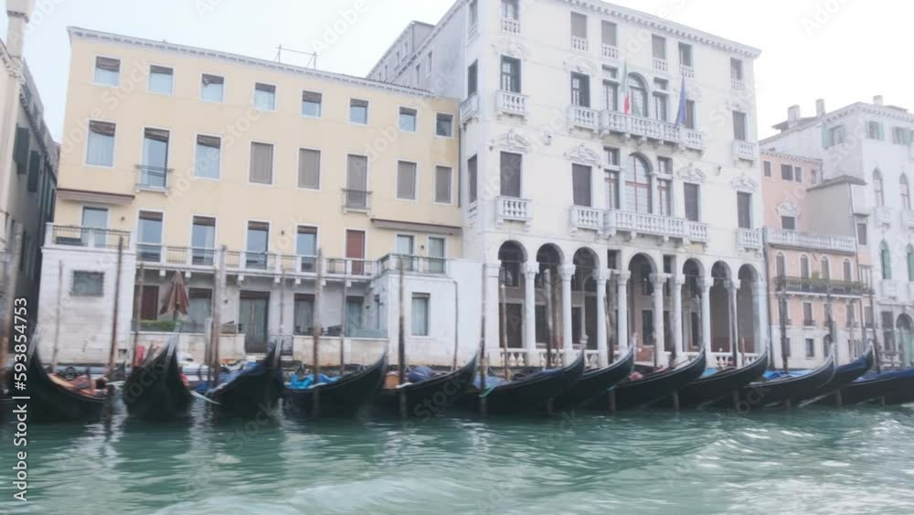 Passing many moored Gondolas on the Grand Canal, winter day in Venice Passing many moored Gondolas on the Grand Canal, winter day in Venice