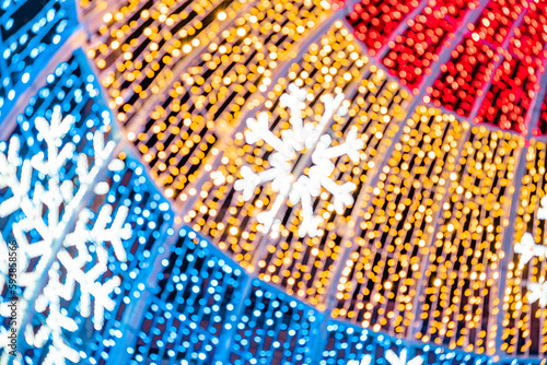 Abstract lights. Christmas street decoration lights, out of focus, in the shape of circles.  Blue, gold and red lights, with black background. Tenerife, Canary Islands, Spain. © Jess