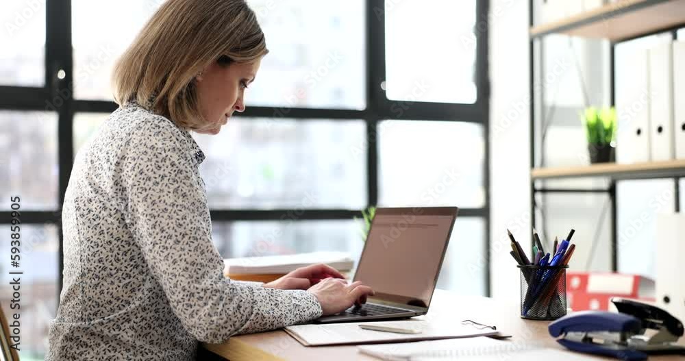 Serious business woman working with laptop in office. Manager secretary and business correspondence in online chat Serious business woman working with laptop in office. Manager secretary and business correspondence in online chat