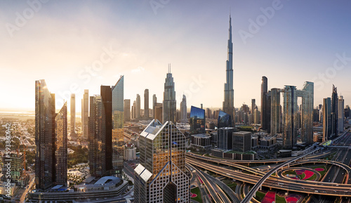 Foto Dramatic sunrise over Dubai skyline panorama with Burj Khalifa and luxury skyscr