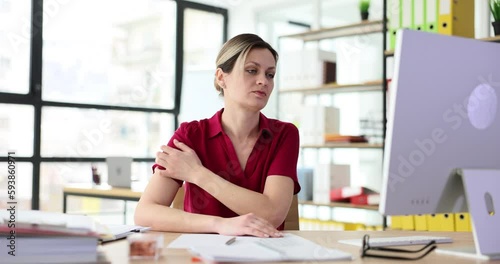 Woman nervously scratches skin of neck in office. Psychogenic itching causes and symptoms