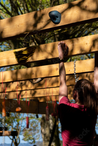a female participant in an obstacle course during one of the races, ocr race