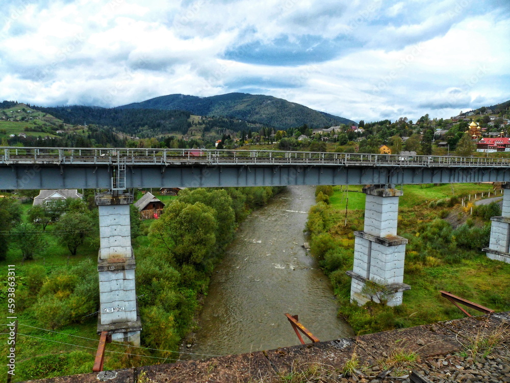 Fototapeta premium Railway bridge across the river in the mountains