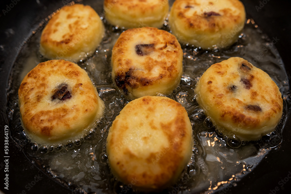 fresh tasty cheese pancakes cheesecakes are fried in a pan, ukraine traditional food