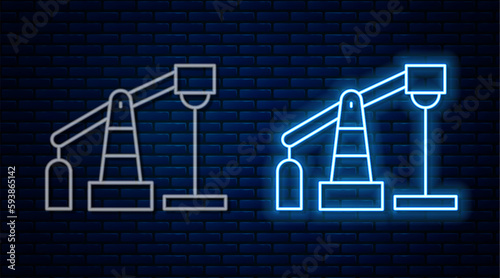 Glowing neon line Oil pump or pump jack icon isolated on brick wall background. Oil rig. Vector