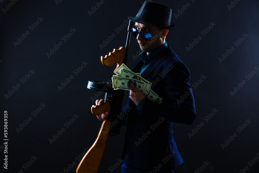 businessman in sunglasses and with a machine gun.