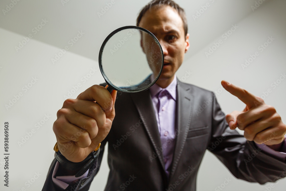 Man hand holding magnifying glass. Data search and analysis, conducting research, nuances, important details study, preparation for exams concept Man hand holding magnifying glass. Data search and analysis, conducting research, nuances, important details study, preparation for exams concept