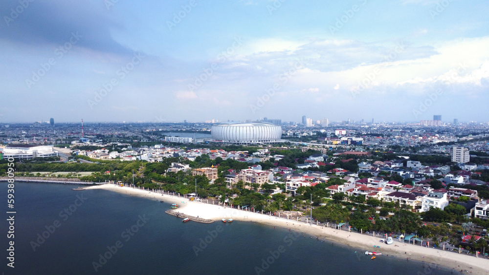 Aerial view of Beach Pier and Beach Pool at Ancol with Jakarta International Stadium in the background, Indonesia