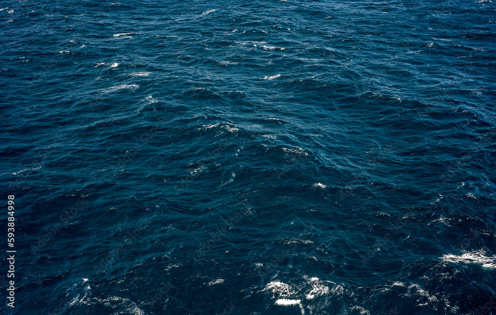 Ocean, sea, background and texture. Blue water background. Ripple sea ocean water surface. close up blue water surface at deep ocean. Dark blue background Ocean, sea, background and texture. Blue water background. Ripple sea ocean water surface. close up blue water surface at deep ocean. Dark blue background