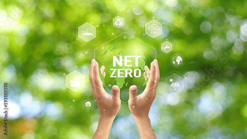 Hand holding green leaf with Net-Zero icons. CO2 Net-Zero Emission - Carbon Neutrality concept.