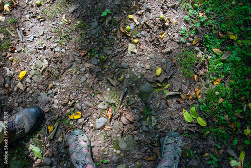 High angle view of an man and woman's feet on hiking trail