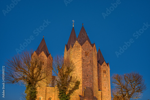 the five towers of Kalundborg church illuminated during the twilight hour photo