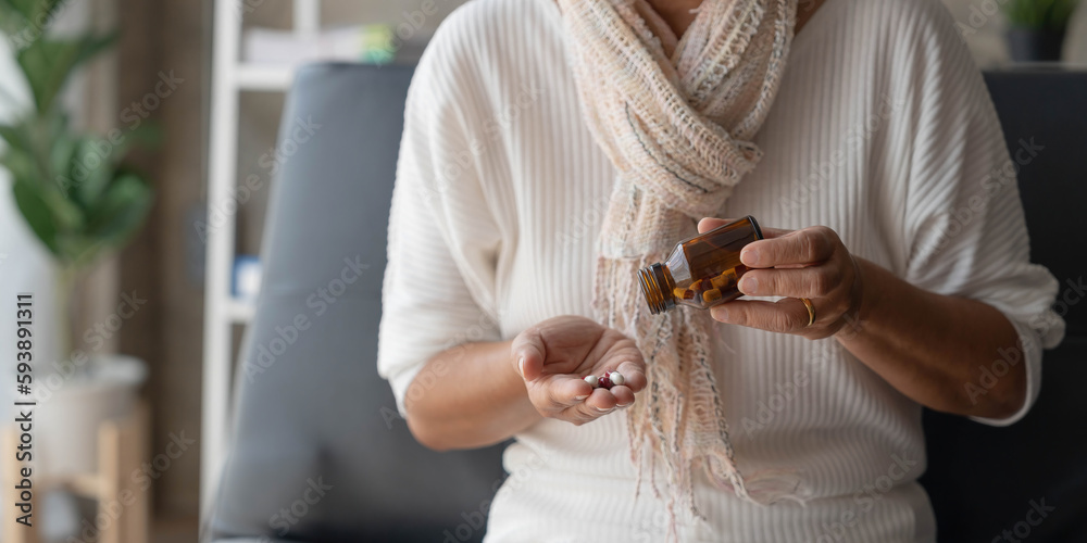 Asian old woman buy herbal self cure Rx pill online from pharmacy, worried senior woman with medicine pills she read on see how to take pills before taking, home isolation, Medical service concept - obrazy, fototapety, plakaty 