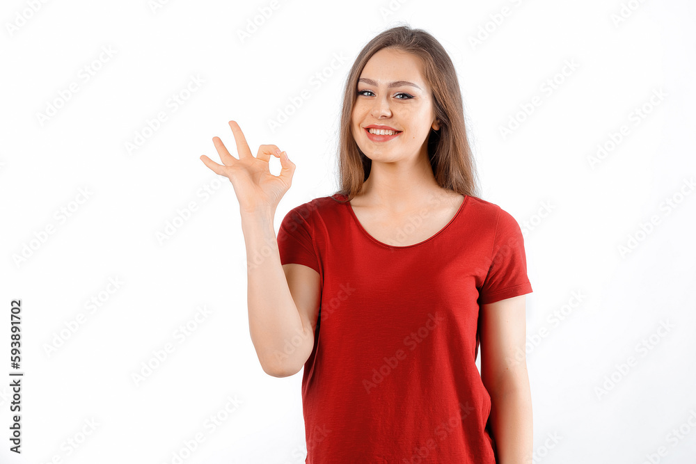 Okay, perfect. Smiling beautiful brunette girl, showing ok, zero gesture, no problem sign, recommending something, standing satisfied against white background Okay, perfect. Smiling beautiful brunette girl, showing ok, zero gesture, no problem sign, recommending something, standing satisfied against white background