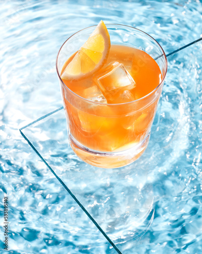 cocktail and lemon in the pool