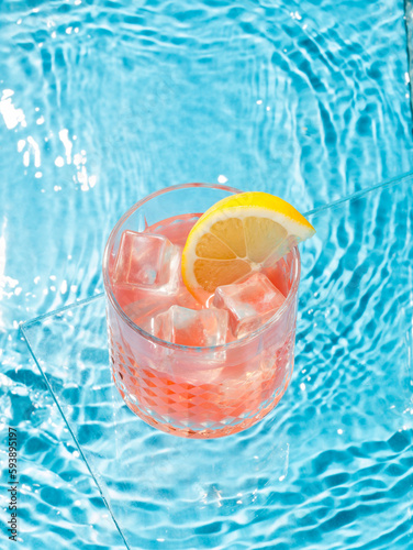 cocktail and lemon in the pool