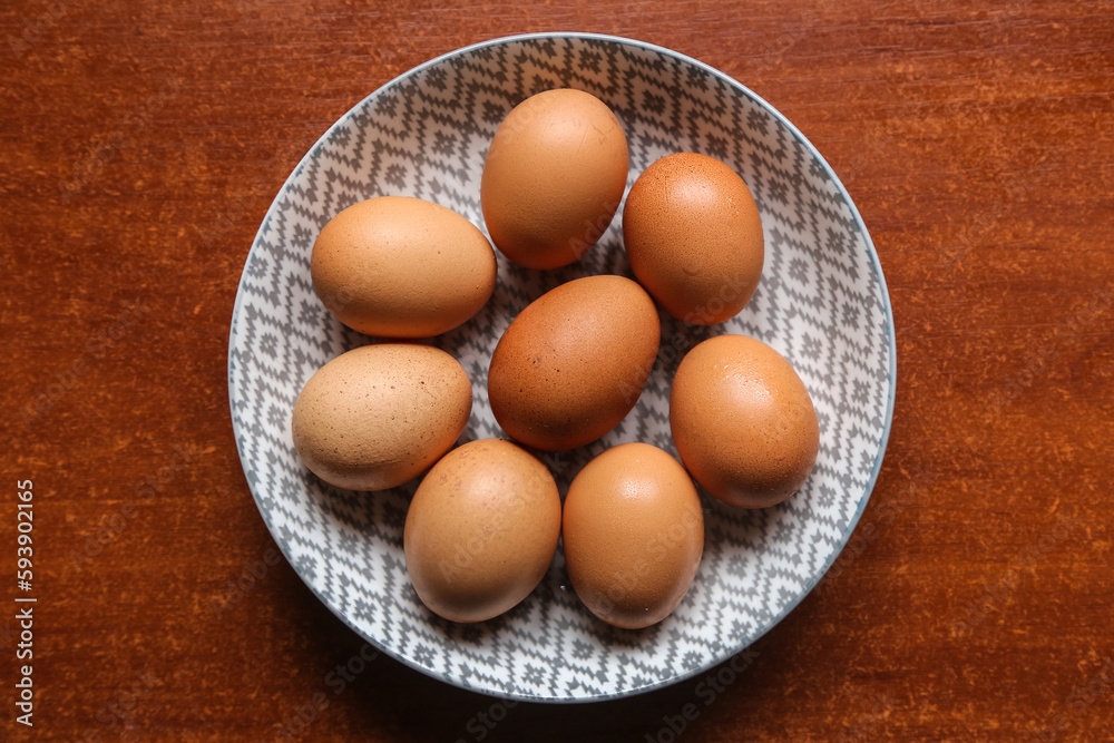egg ingredient egg in a plate on a dark wooden table on a dark surface egg ingredient egg in a plate on a dark wooden table on a dark surface