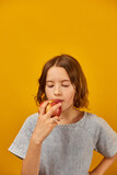 Pretty teen girl, child eat, bites a fresh red apple