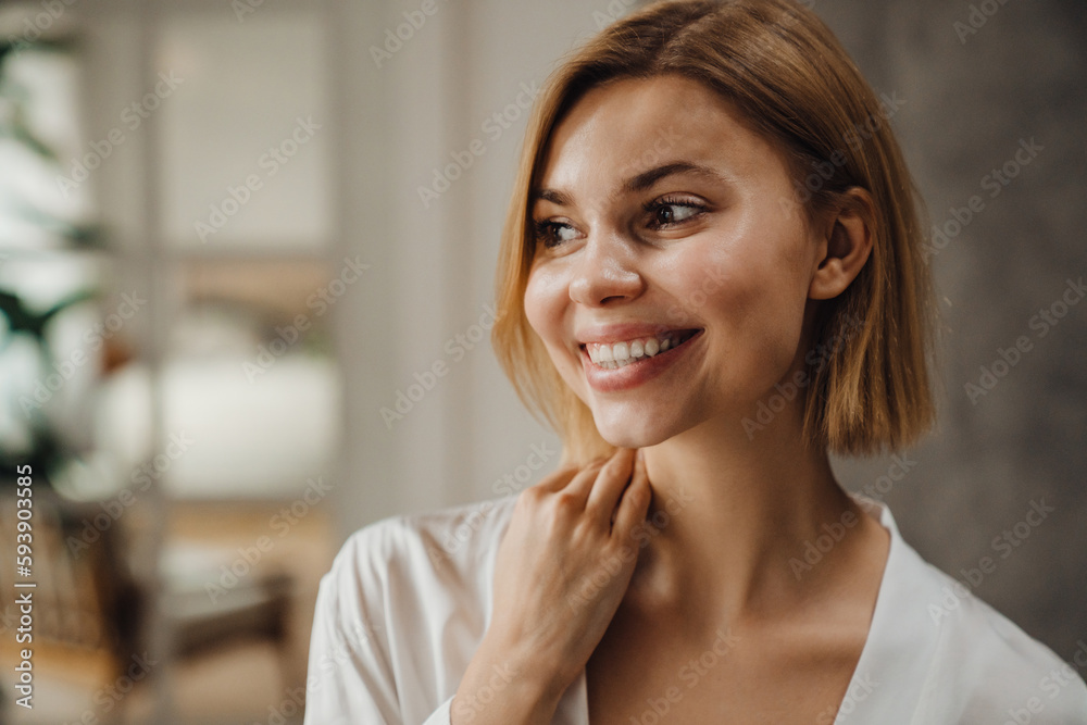 Beautiful woman smiling while standing at home Beautiful woman smiling while standing at home