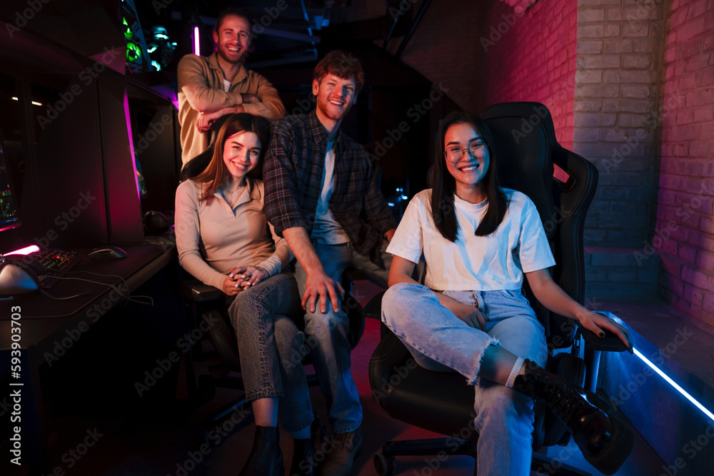 Team of gamers sitting in cybersport club