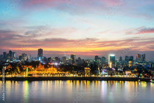 Sunset over Phnom Penh and the Royal Palace viewed from eastern side of Tonle Sap river Cambodia.