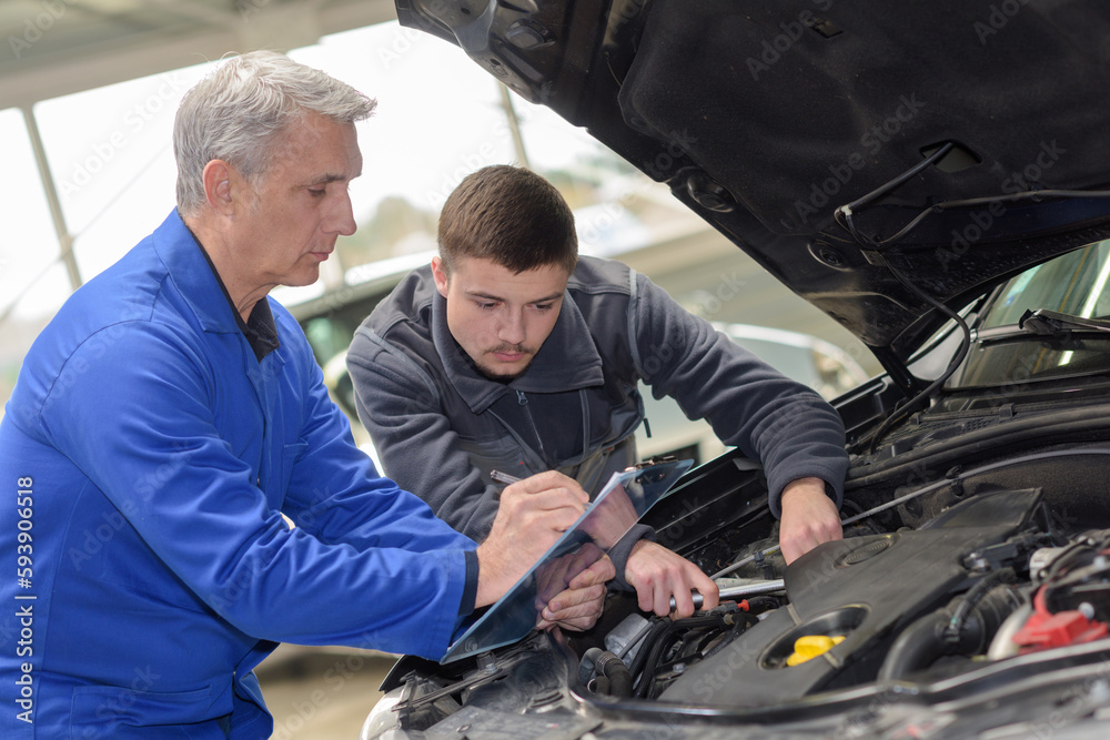 mechanic checked in the engine compartment of a car mechanic checked in the engine compartment of a car