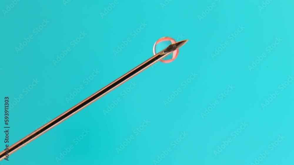 Metal syringe needle close-up on a blue background. Metal syringe needle close-up on a blue background.