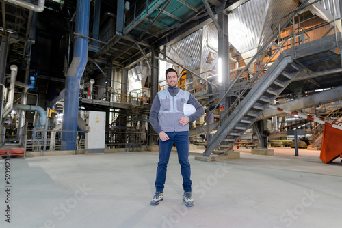 full length portrait of male enginer in factory
